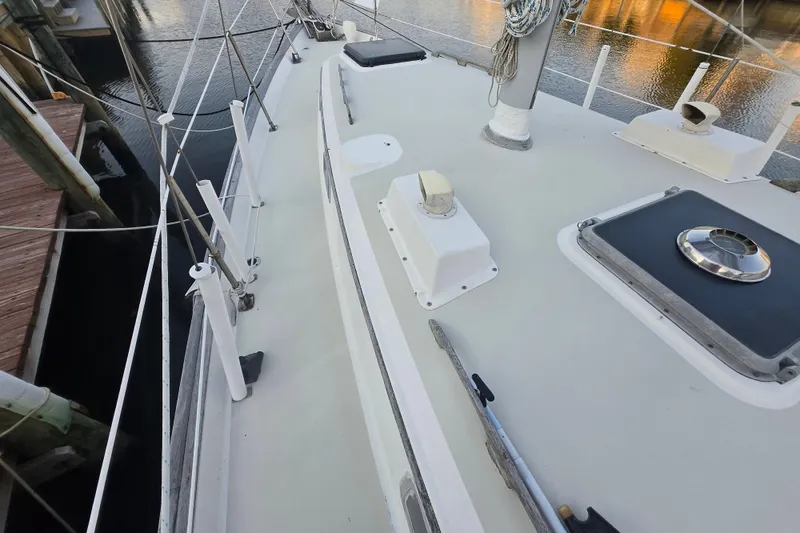 Slide: The Image of Deck view of a 1980 Pearson 365 Sloop sailboat docked by the water. - 28