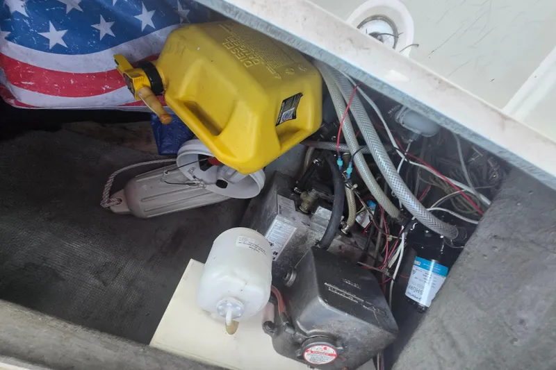 Slide: The Image of Engine compartment of a 1980 Pearson 365 Sloop with fuel container and wiring. - 35