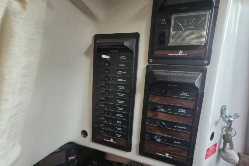 Slide: The Image of Electrical panel of a 1980 Pearson 365 Sloop sailboat, featuring various switches and gauges. - 42