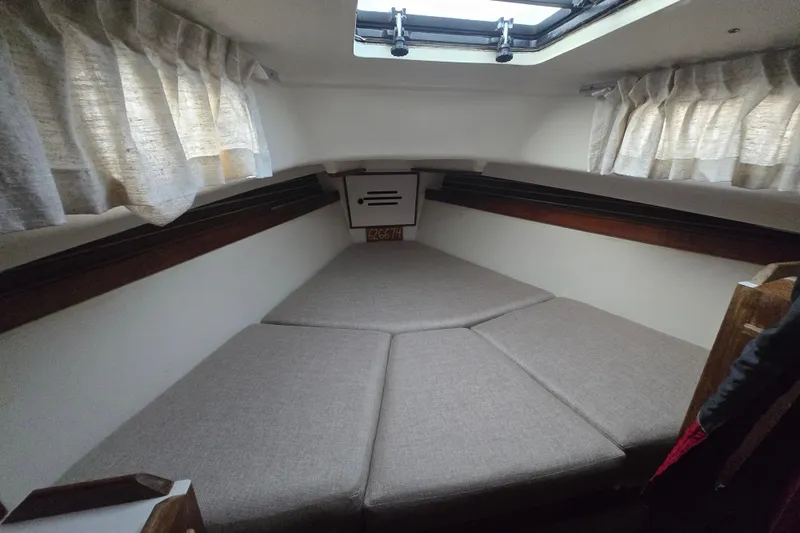 Slide: The Image of Interior cabin of a 1980 Pearson 365 Sloop sailboat with cozy bedding and curtains. - 45