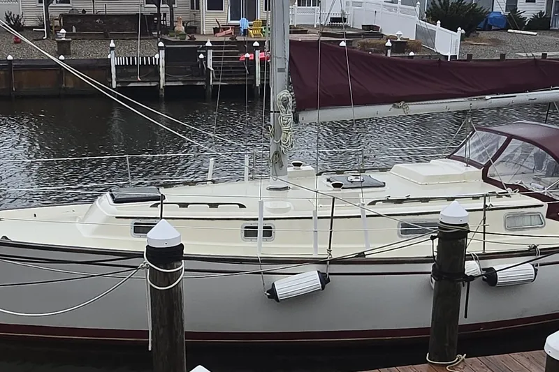 Slide: The Image of Cozy interior of a 1980 Pearson 365 Sloop with wooden furnishings and nautical decor. - 6