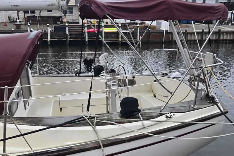 Slide: The Image of 1980 Pearson 365 Sloop docked in a marina with maroon canopy. - 8