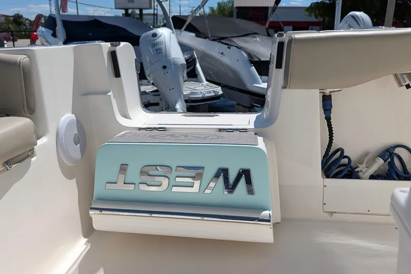 Slide: The Image of 2023 Key West 263 FS boat interior with seating and storage compartments. - 12