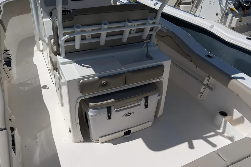 Slide: The Image of 2023 Key West 263 FS boat interior with seating, storage, and rod holders. - 13