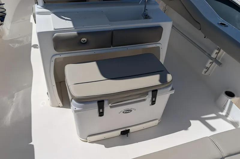 Slide: The Image of 2023 Key West 263 FS boat interior with cushioned seating and storage. - 14