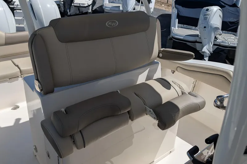 Slide: The Image of 2023 Key West 263 FS boat seating with beige upholstery and armrests. - 15