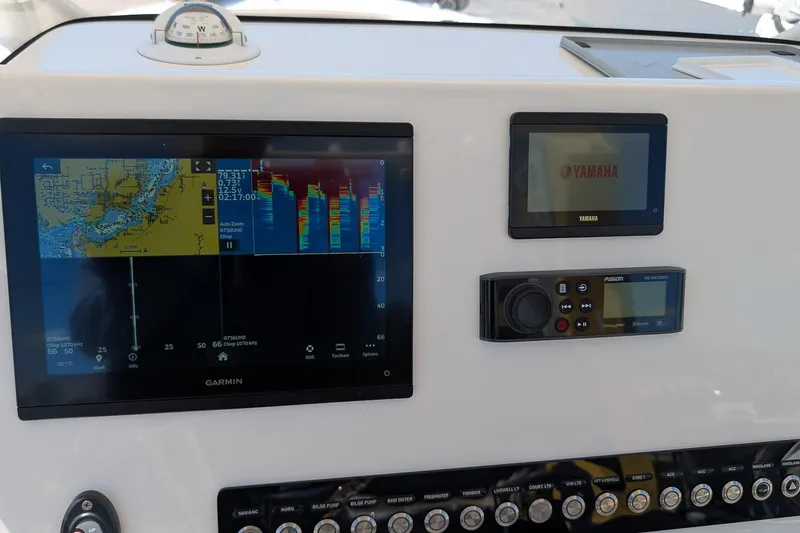 Slide: The Image of 2023 Key West 263 FS boat dashboard with Garmin and Yamaha displays. - 17