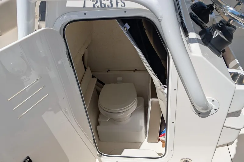 Slide: The Image of 2023 Key West 263 FS boat interior with compact marine toilet. - 19
