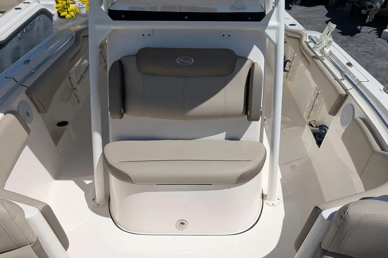 Slide: The Image of 2023 Key West 263 FS boat interior with beige seating and storage compartments. - 20