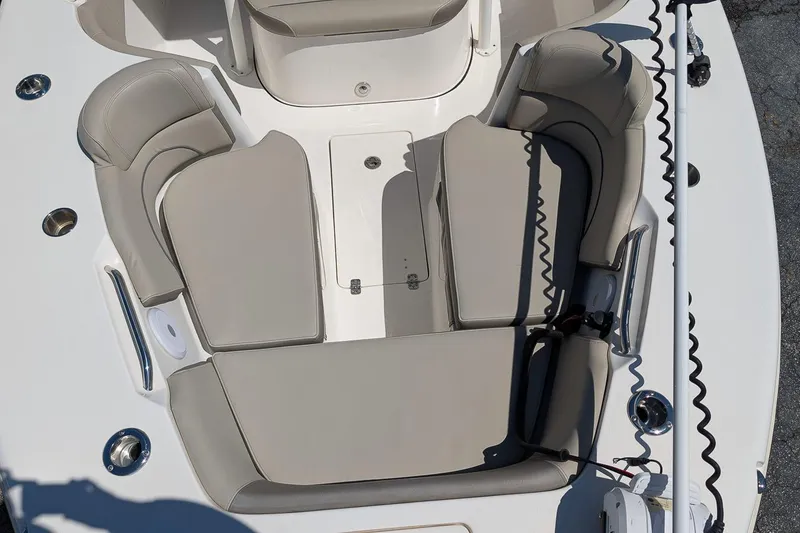 Slide: The Image of 2023 Key West 263 FS boat interior with cushioned seating and storage compartments. - 25