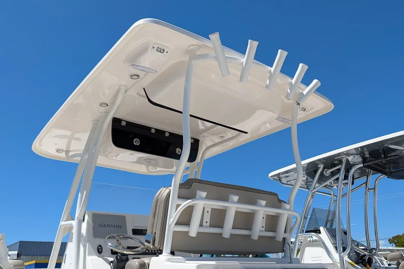 Slide: The Image of 2023 Key West 263 FS boat with T-top and rod holders under clear blue sky. - 26