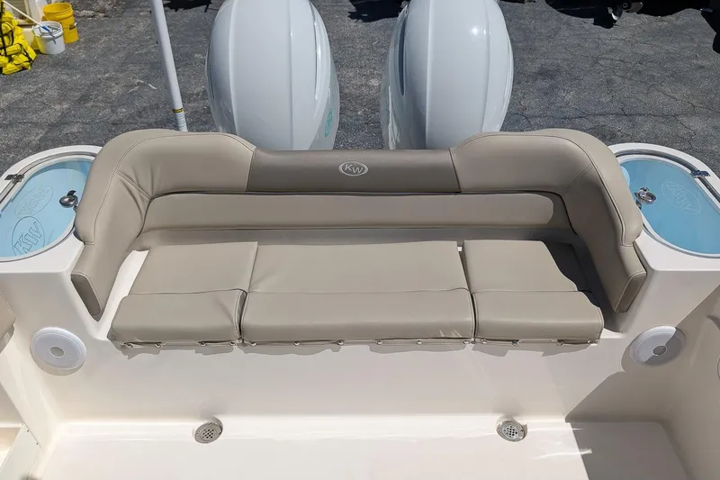 Slide: The Image of 2023 Key West 263 FS boat with beige seating and dual outboard motors. - 8