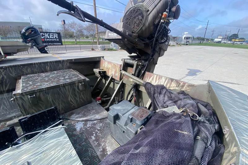 Slide: The Image of 2009 Gator Trax MUD BUDDY 17 X 50 boat interior with motor and equipment. - 14