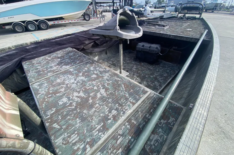 Slide: The Image of 2009 Gator Trax MUD BUDDY boat with camouflage interior, docked at marina. - 17