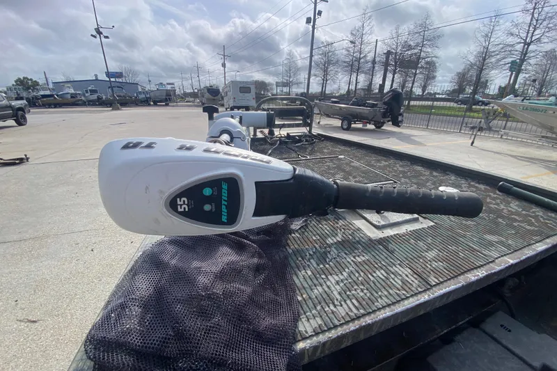 Slide: The Image of 2009 Gator Trax MUD BUDDY boat with Riptide trolling motor in a parking lot. - 20