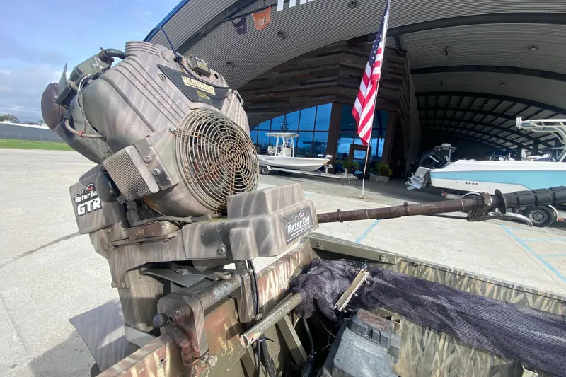 Slide: The Image of 2009 Gator Trax MUD BUDDY boat motor at marina with American flag. - 21