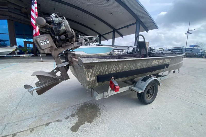 Slide: The Image of 2009 Gator Trax MUD BUDDY 17 X 50 boat on trailer, outdoor setting. - 4