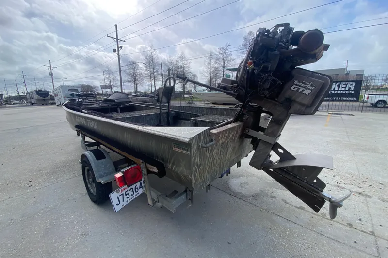 Slide: The Image of 2009 Gator Trax MUD BUDDY 17 X 50 boat with trailer in parking lot. - 6