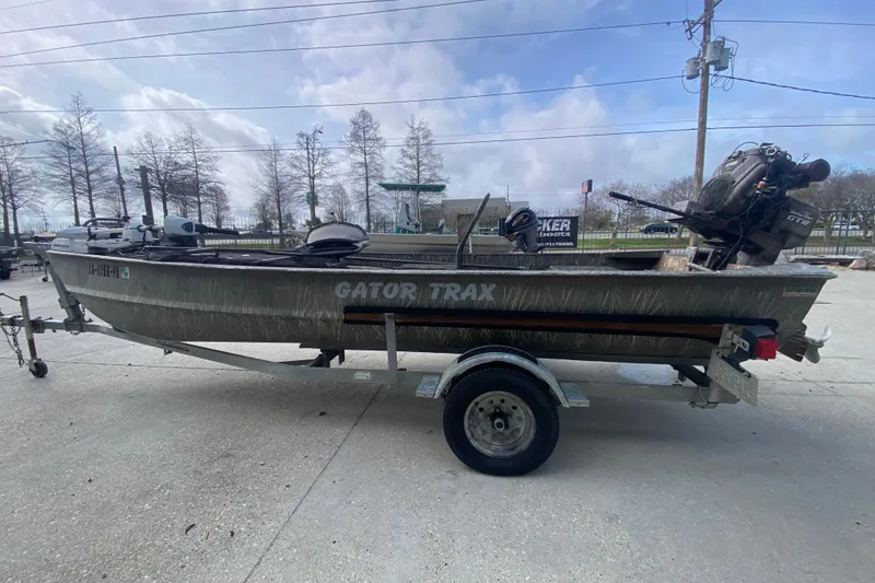 Slide: The Image of 2009 Gator Trax MUD BUDDY 17 X 50 boat on trailer, outdoor setting. - 7