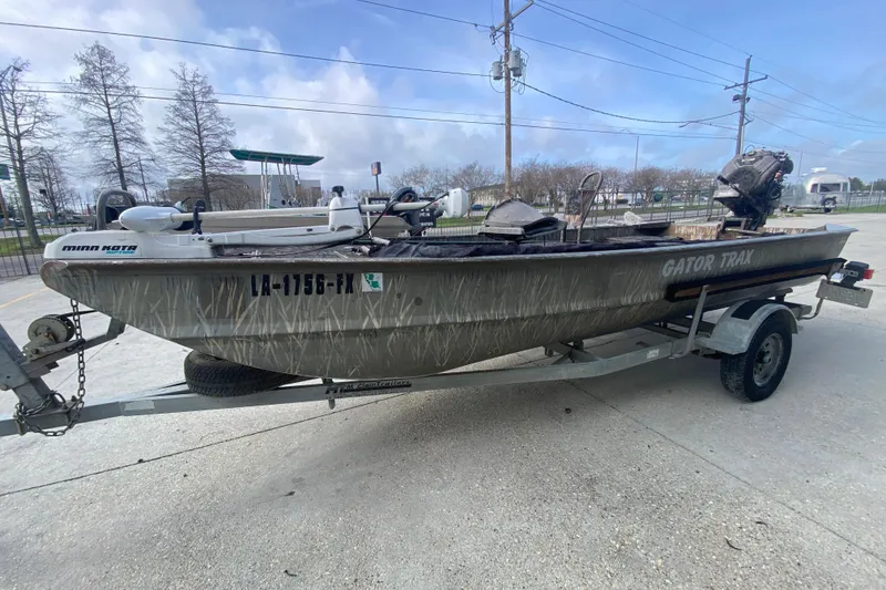 Slide: The Image of 2009 Gator Trax MUD BUDDY boat on trailer, parked outdoors. - 8