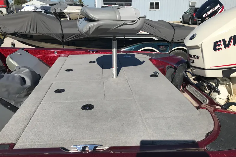 Slide: The Image of 2008 Triton 18 Explorer boat with Evinrude motor, featuring a spacious deck and seating. - 12