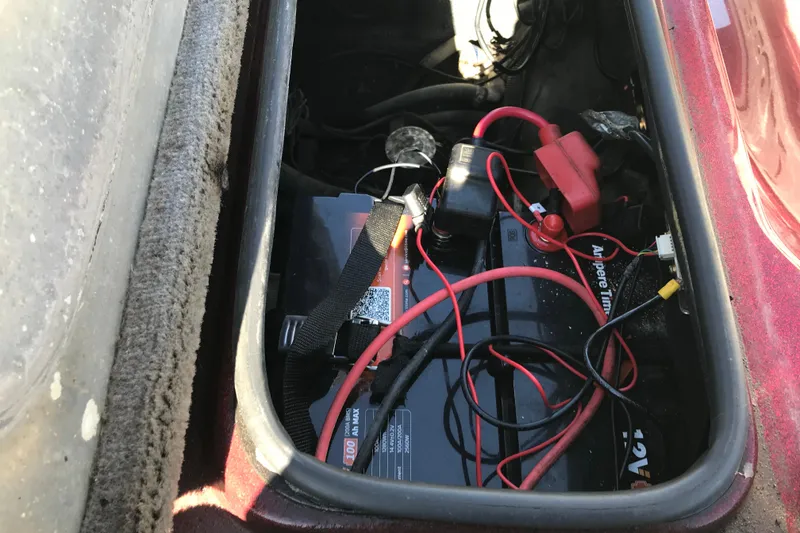 Slide: The Image of Battery compartment of a 2008 Triton 18 Explorer with visible wiring and connections. - 13