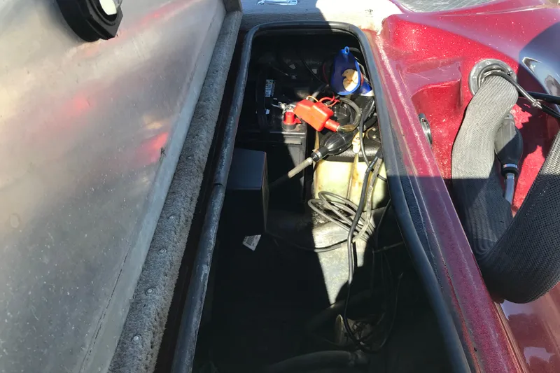 Slide: The Image of Open storage compartment of a 2008 Triton 18 Explorer boat, showing battery and wiring. - 14