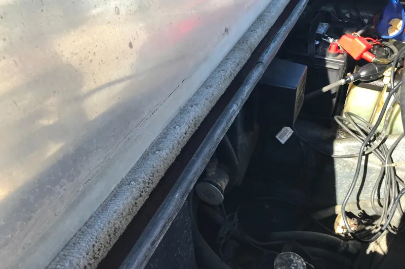 Slide: The Image of Engine compartment of a 2008 Triton 18 Explorer boat with visible wiring and components. - 17