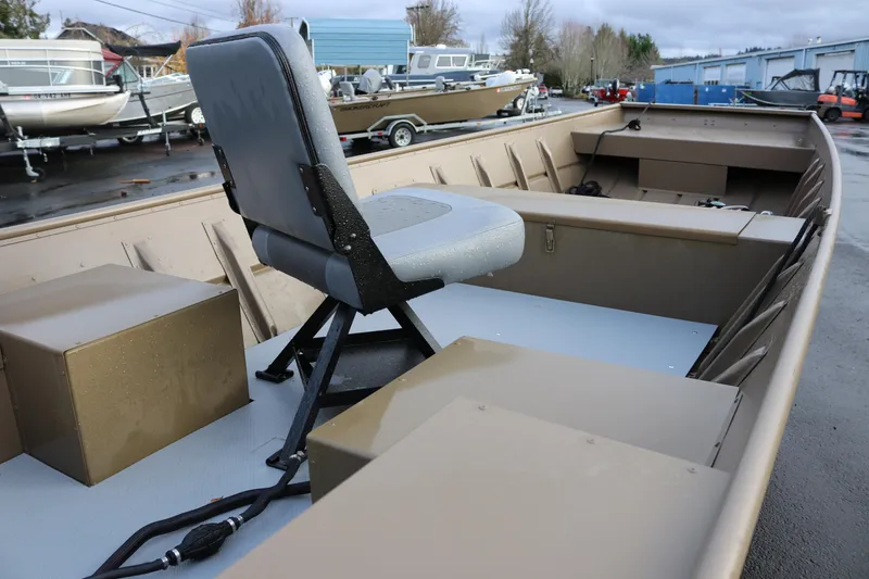 Slide: The Image of 2025 Smoker Craft 1648 Jon boat with seating, parked outdoors. - 10