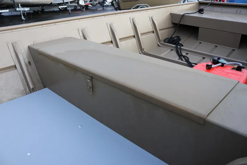 Slide: The Image of 2025 Smoker Craft 1648 Jon boat interior with storage compartment and fuel tank. - 11