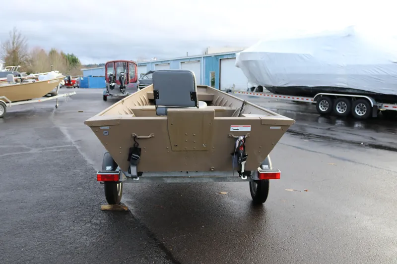 Slide: The Image of 2025 Smoker Craft 1648 Jon boat on trailer in outdoor lot. - 2