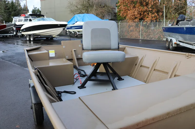 Slide: The Image of 2025 Smoker Craft 1648 Jon boat with swivel seat, parked outdoors. - 8