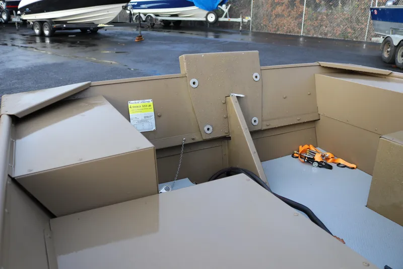 Slide: The Image of 2025 Smoker Craft 1648 Jon boat interior with storage compartments and safety equipment. - 9