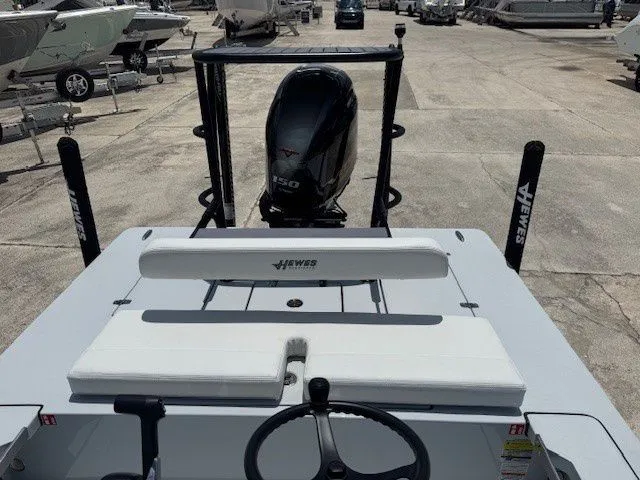 Slide: The Image of 2026 Hewes Redfisher 18 boat with outboard motor at shipyard. - 22