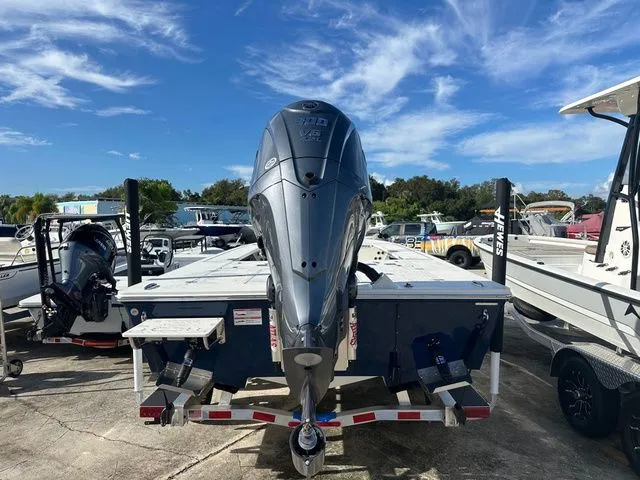 Slide: The Image of 2026 Hewes Redfisher 21 boat with outboard motor on trailer. - 14