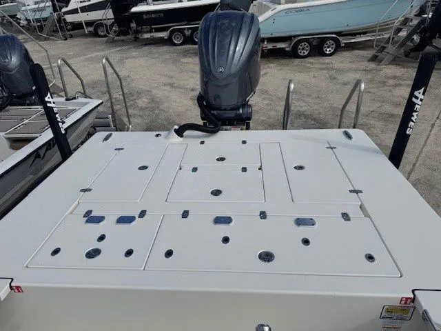 Slide: The Image of Hewes Redfisher 21 boat, 2026 model, with outboard motor on a boat deck. - 15