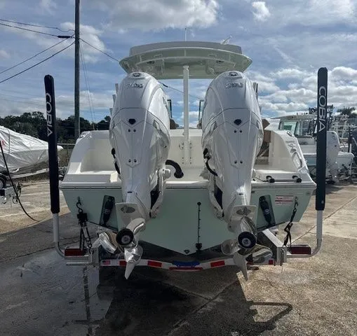 Slide: The Image of 2026 Cobia 280 Dual Console with twin outboard engines. - 24