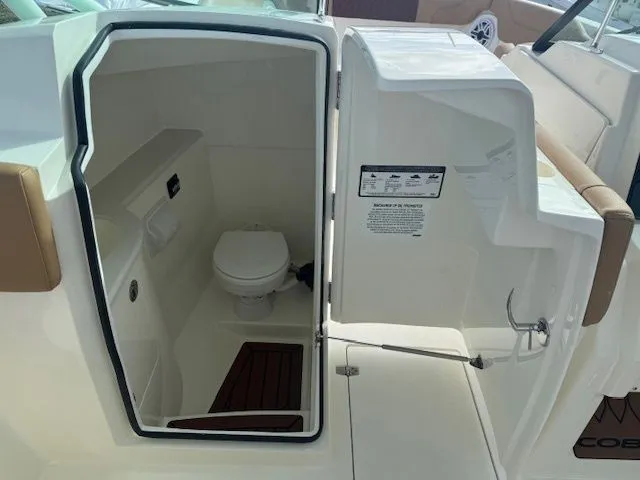 Slide: The Image of Interior of 2026 Cobia 280 Dual Console featuring a toilet. - 32