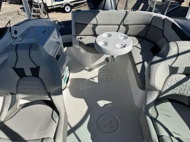 Slide: The Image of Interior of 2026 Hurricane SunDeck 2400 OB with gray seating and table. - 25