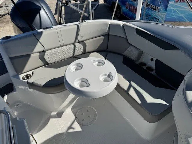 Slide: The Image of Interior of 2026 Hurricane SunDeck 2400 OB with table and seating area. - 26
