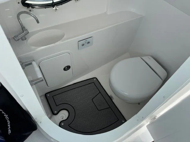 Slide: The Image of Interior of 2026 Hurricane SunDeck 2400 OB with toilet and sink. - 31