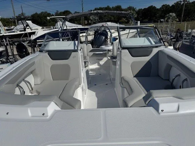 Slide: The Image of 2026 Hurricane SunDeck 2050 OB boat with gray seating at the marina. - 23
