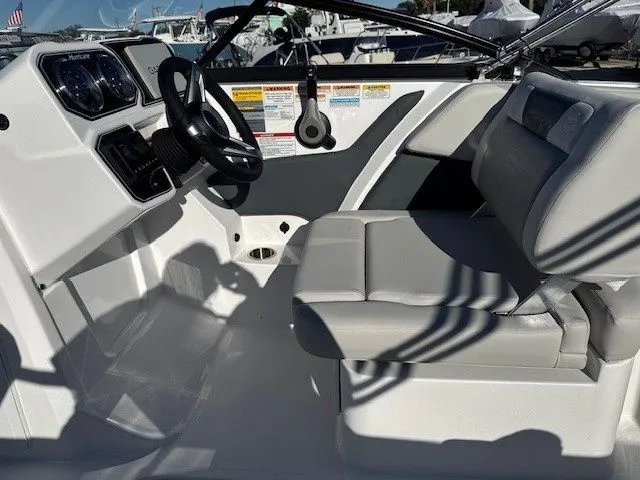 Slide: The Image of Interior of 2026 Hurricane SunDeck 2050 OB with helm console and seating. - 24
