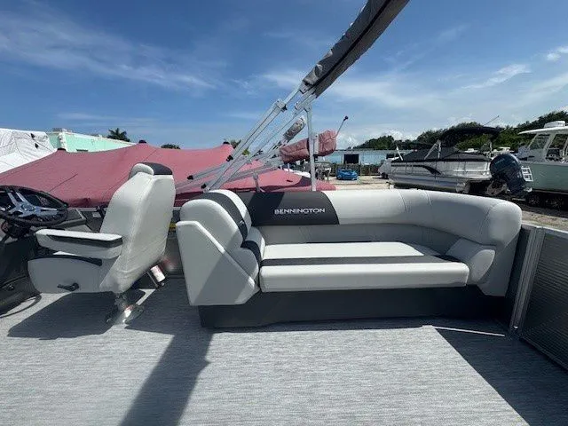 Slide: The Image of Bennington 22SSRSE 2026 pontoon boat with gray seating and helm. - 27