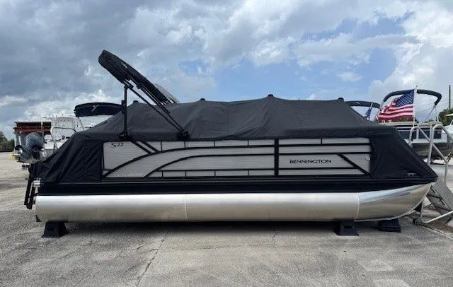 Slide: The Image of Bennington 22SSRSE 2026 pontoon boat with cover on parking lot. - 28