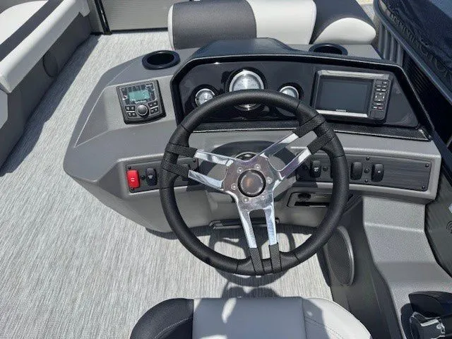 Slide: The Image of 2026 Bennington 22SSRSE helm with modern controls and instruments. - 35