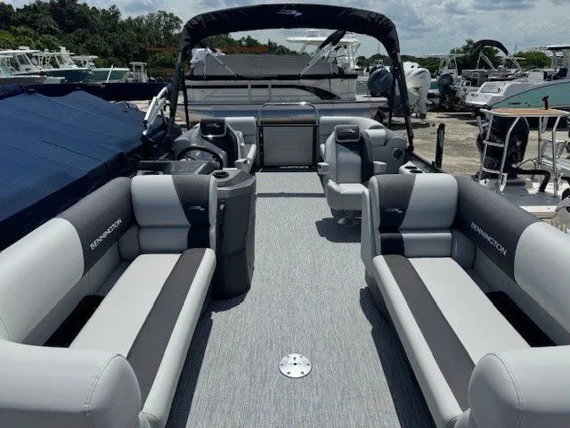 Slide: The Image of 2026 Bennington 22SSRSE pontoon boat with luxurious interior at the marina. - 37