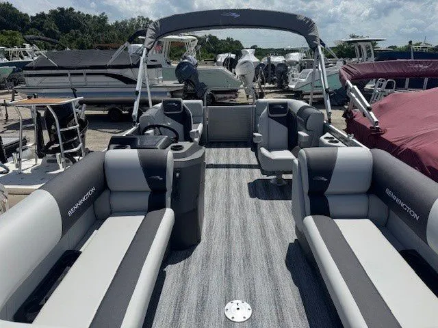 Slide: The Image of 2026 Bennington 20SSRSE pontoon boat with gray seating at the dock. - 23