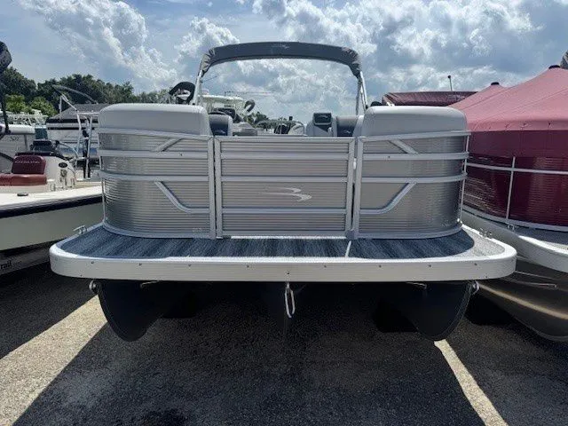 Slide: The Image of 2026 Bennington 20SSRSE pontoon boat parked outdoors. - 24