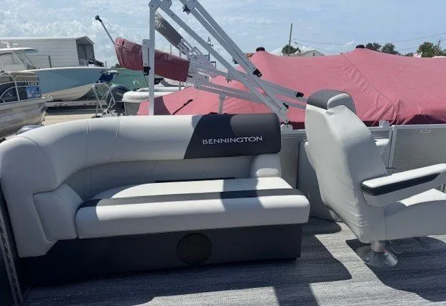 Slide: The Image of Interior of a 2026 Bennington 20SSRSE pontoon boat with gray seating. - 27